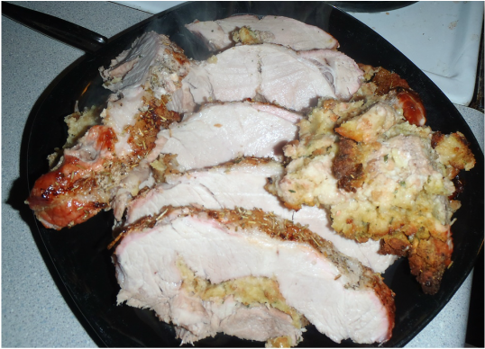 plate full of sliced stuffed boneless pork roast