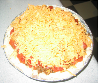 pie topped with tomato and shredded cheesePicture