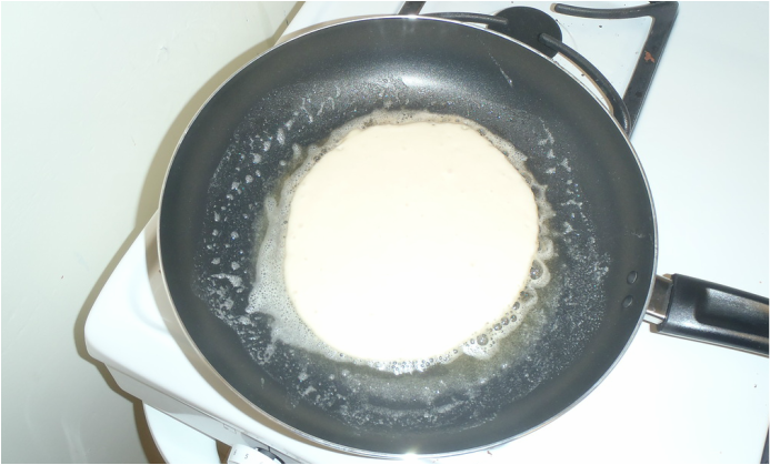Pancake in frying pan before flipping