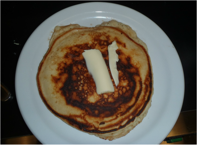Plated pancake topperd with butter 