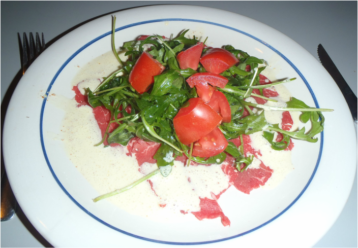 plated beef carpaccio with arugula salad Picture