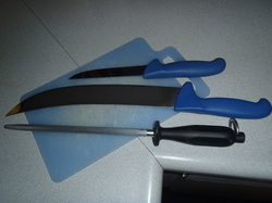 Butcher equipment including a cutting board, steel, boneing knife and steak knife