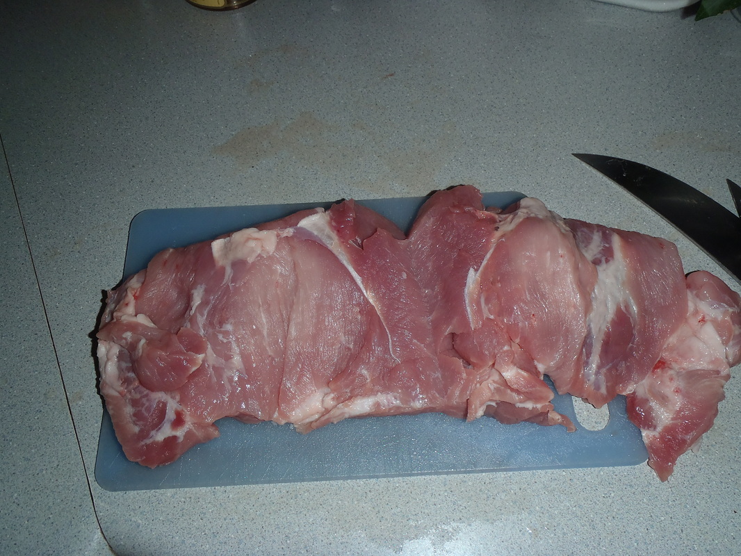 sliced boneless pork roast prepared to be stuffed