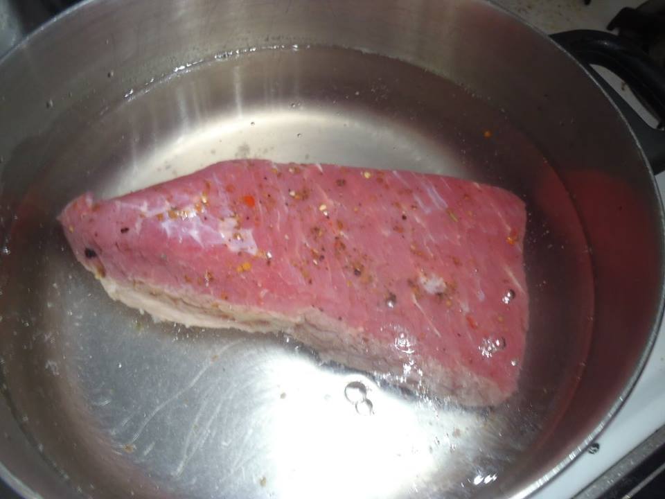 Picture corned beef brisket in a pot of water