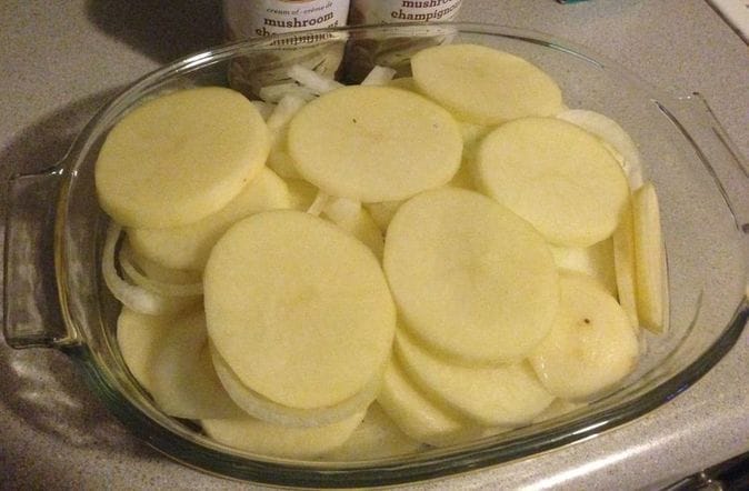 2 quart casserole dish with sliced potatoes and onions Picture