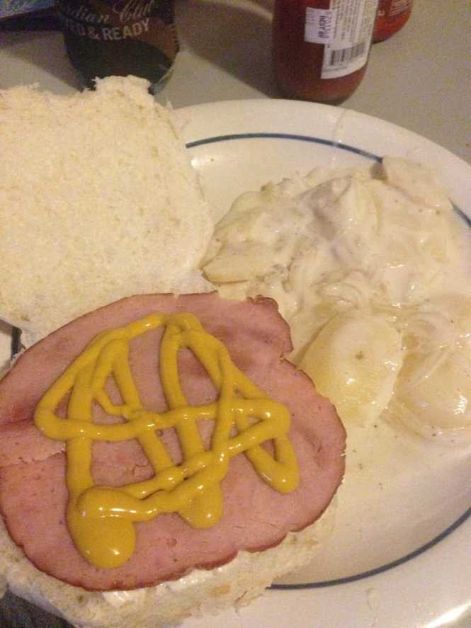 Plated scalloped potatoes with a ham on a bun Picture